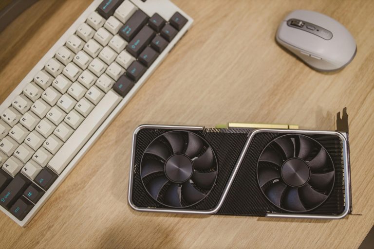 Top view of a desktop with a keyboard, mouse, and graphics card.